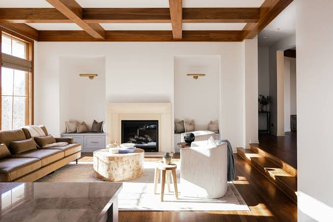 Living room with exposed wood beams and a fireplace