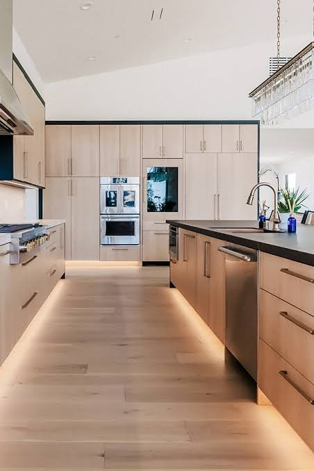 Kitchen with light oak cabinets and under-cabinet lighting