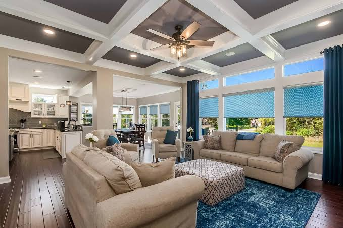 Living room with a coffered ceiling and blue accents