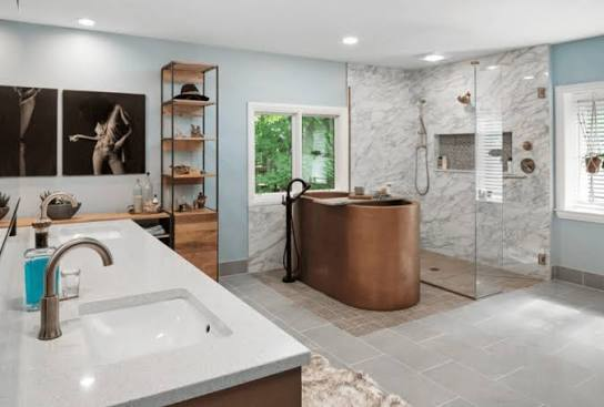 Bathroom with a freestanding copper tub and marble shower